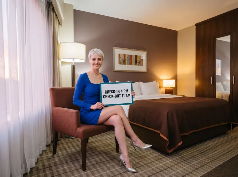 Woman in a hotel room with a check-in card